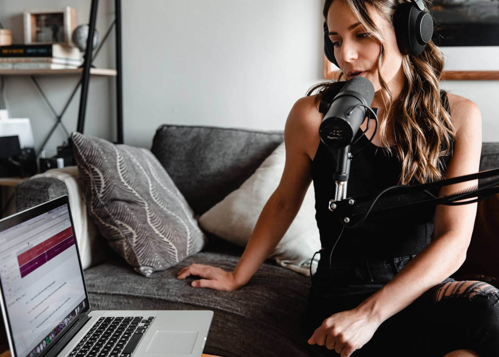 Woman speaking into mic at computer